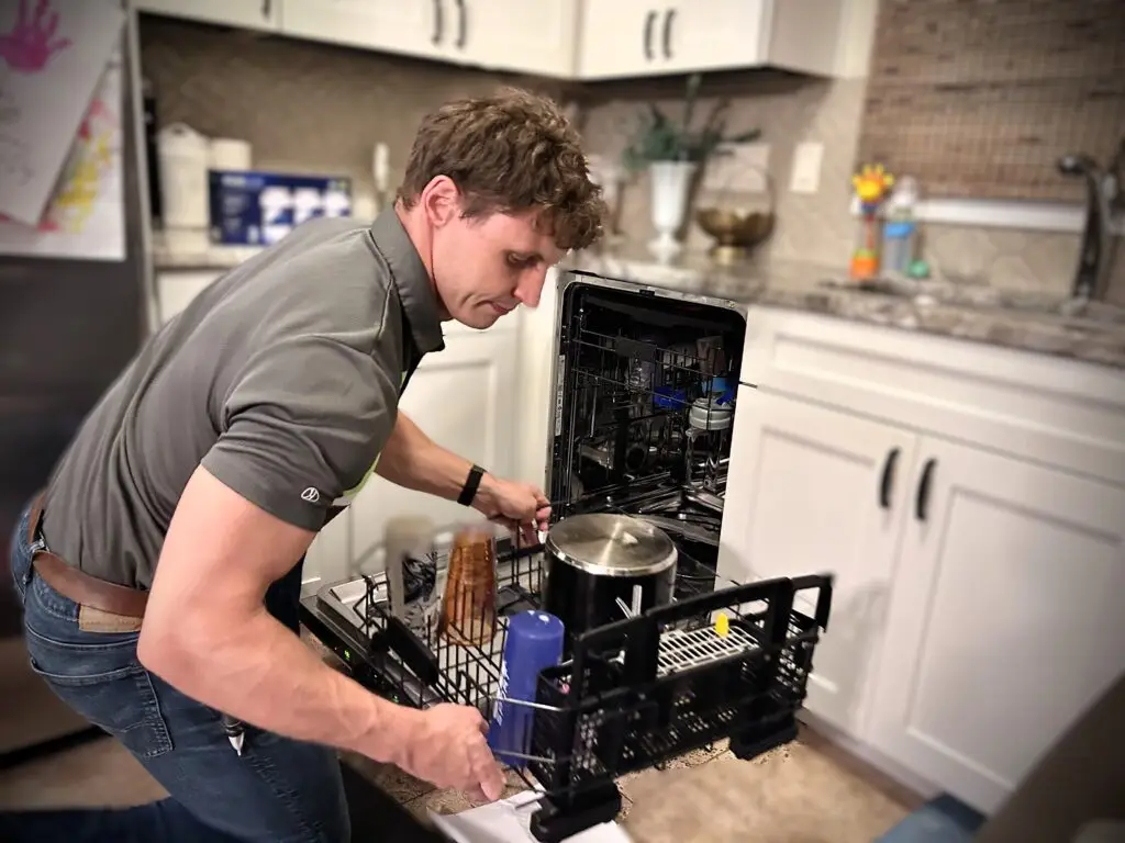 Adam Bigelow, CEO of BA Appliance Repair, fixing a dishwasher in Cincinnati.