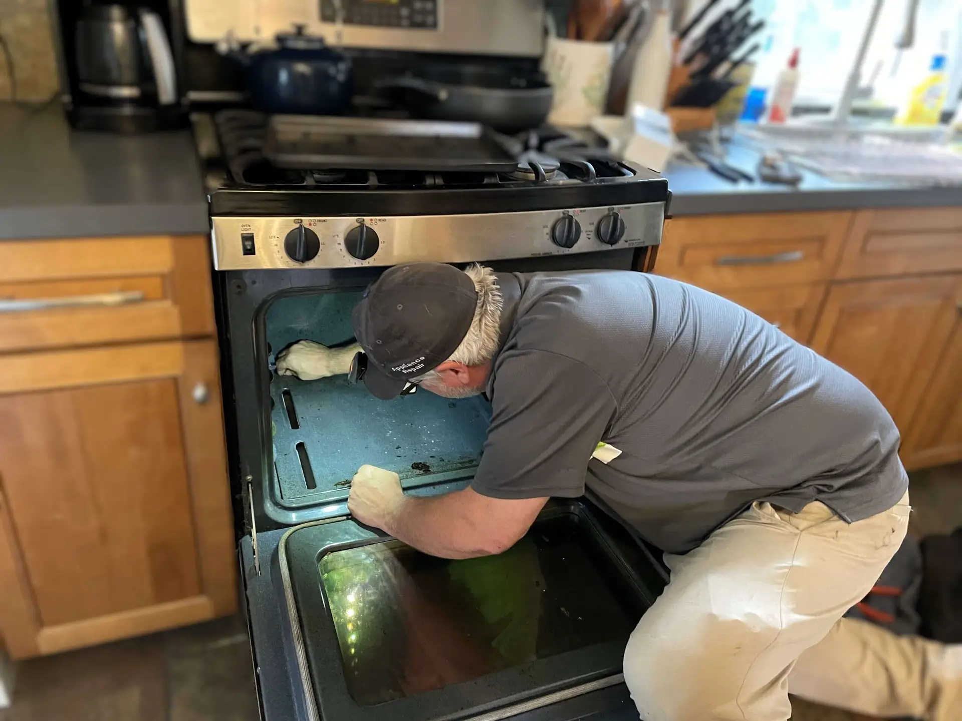 Bill, a technician from BA Appliance Repair Service, performing range repair in Cincinnati.
