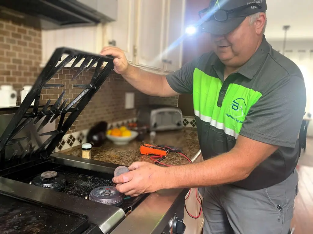 Technician repairing a JP range stove, demonstrating professional appliance repair services provided by BA Appliance Repair Service.