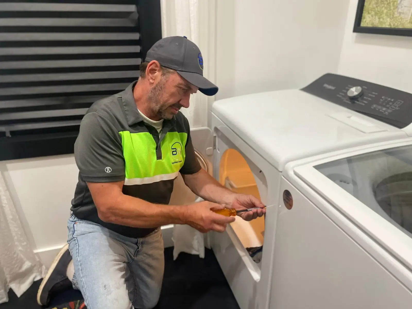 BA Appliance Repair technician repairing a dryer