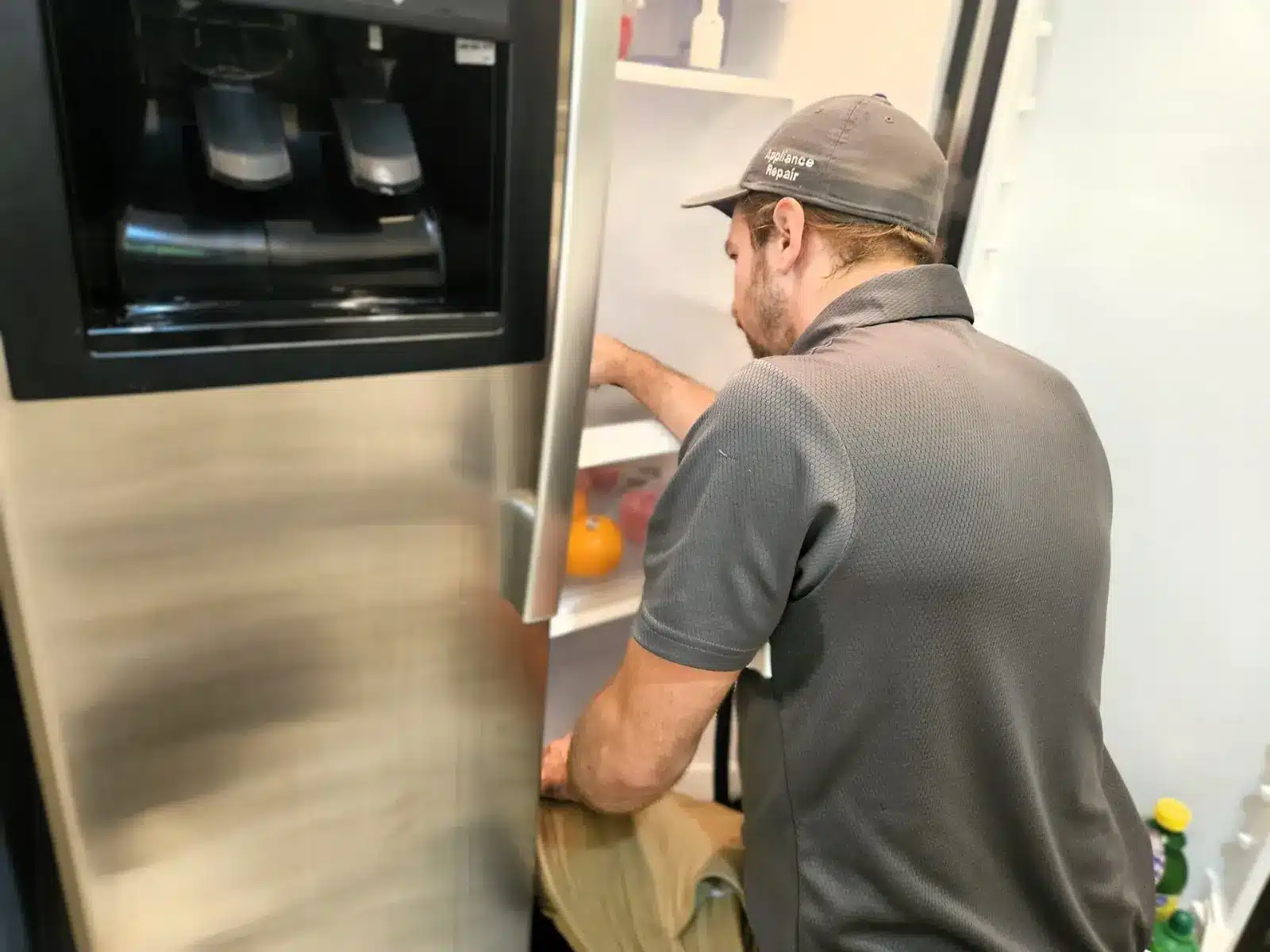 BA Appliance Repair technician servicing a refrigerator in a Cincinnati home