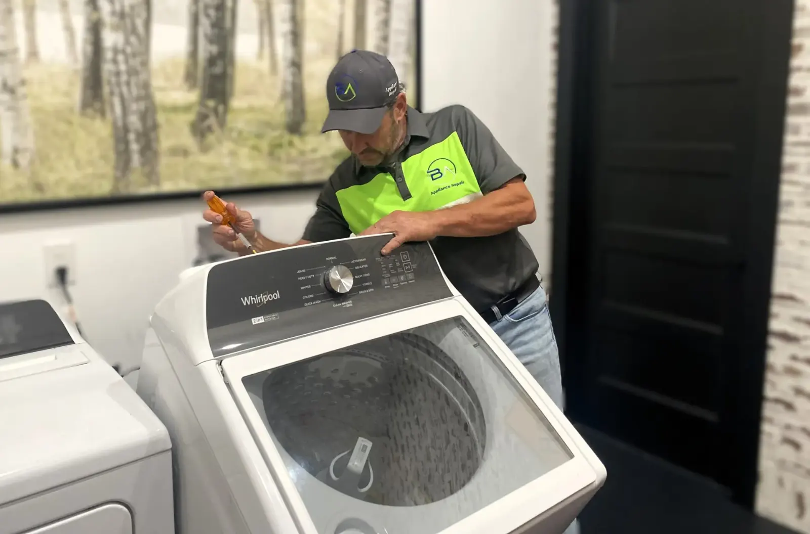 BA Appliance Repair technician working on a washing machine