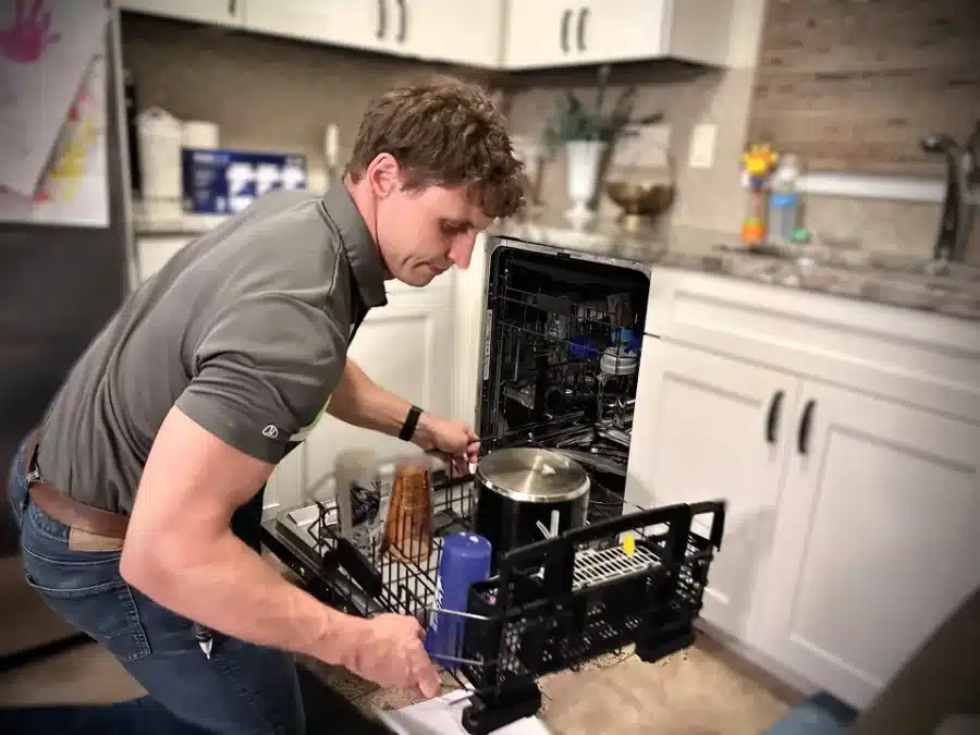 BA technician repairing a dishwasher