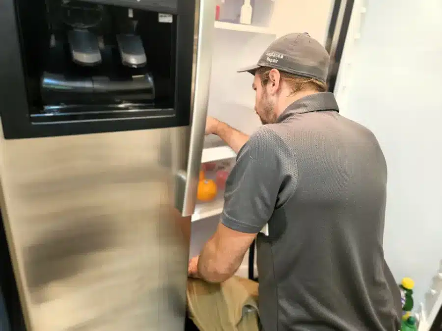 BA technician repairing a refrigerator