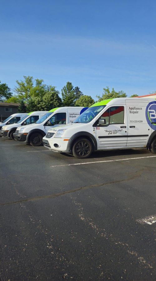 a group of BA Appliance Repair Service vans in a parking lot