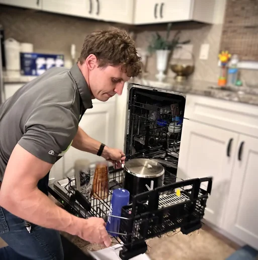 Adam Bigelow, CEO of BA Appliance Repair, fixing a dishwasher in Cincinnati.